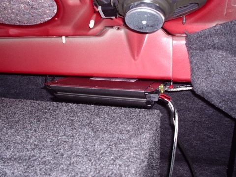 1998 Ford Taurus - Close-up view of a car's interior, showing an amplifier and speaker installation.