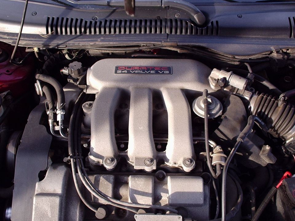 Engine intake manifold with 'Duratec 24 Valve V6' label. Some hoses and wiring visible
