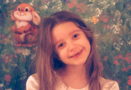 1991 Ford Bronco - A young child smiles in front of a floral backdrop with a bunny decoration.