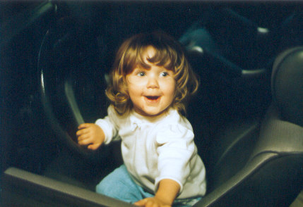 1991 Ford Bronco - Child plays in the interior of a vehicle, with a "SUPERMOTORS" logo in the corner.