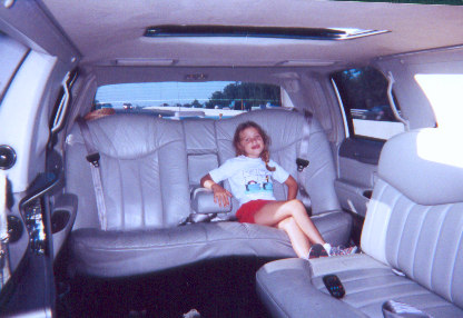 1991 Ford Bronco - Interior view of a limousine with a young girl seated on the rear bench.