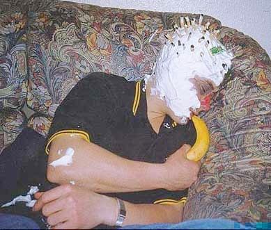1990 Ford Bronco - A person is sitting on a couch with pie on their face and a banana in their mouth, with whipped cream and a banana visible.