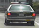 1995 Ford Crown Victoria - Rear view of a police car, likely a sedan, with its distinctive light bar on the roof.