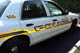 1995 Ford Crown Victoria - This police car has markings on the door and a number on the rear quarter panel.