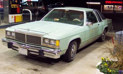1985 Ford Crown Victoria LTD - A light green sedan is parked at a gas station with a CVS store in the background.
