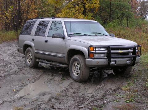 2000 Chevrolet Tahoe - Silver 2000 Chevrolet Tahoe navigating a muddy trail during autumn.