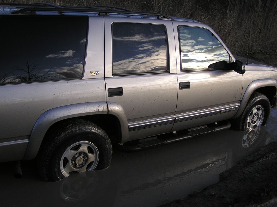 Silver SUV with Z71 badge stuck in mud. Looks like a late 90s model