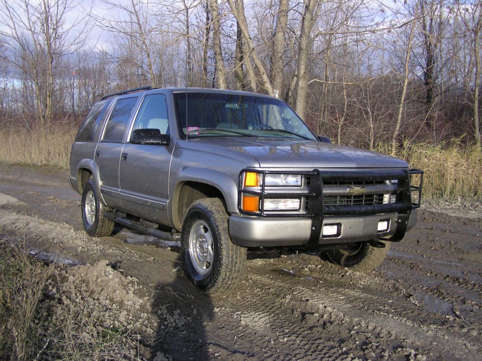 Gray SUV with bull bar on dirt road, 1995 model year