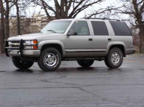 2000 Chevrolet Tahoe - This silver SUV, likely from the late 1990s, is shown from a three-quarter front angle.