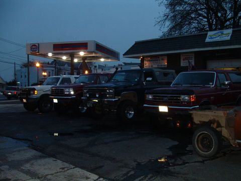 1994 Ford Bronco - SUVs are parked at a gas station, with a red Ford Bronco in the foreground.
