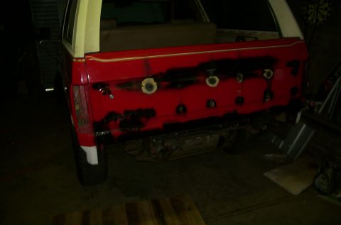 1981 Ford Bronco - Rear gate of a 1981 Ford Bronco undergoing bodywork and paint preparation.