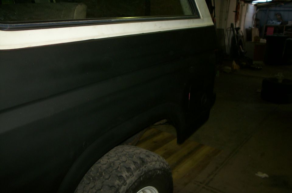1981 Ford Bronco rear quarter panel and tire, painted black with white trim