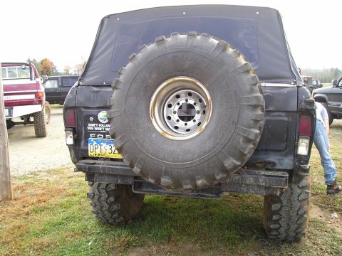 1996 Ford Bronco - Rear view of a 1996 Ford Bronco, equipped with a large spare tire and off-road modifications.