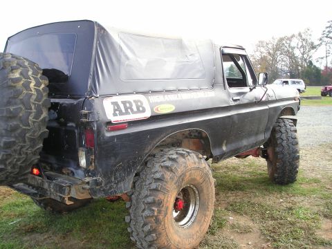 1996 Ford Bronco - This modified Ford Bronco features a soft top and large off-road tires, suggesting it is from the late 1970s.
