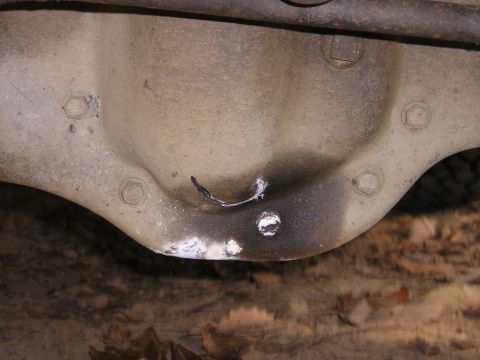 1996 Ford Bronco - Close-up of a damaged differential housing, showing signs of wear and repair.