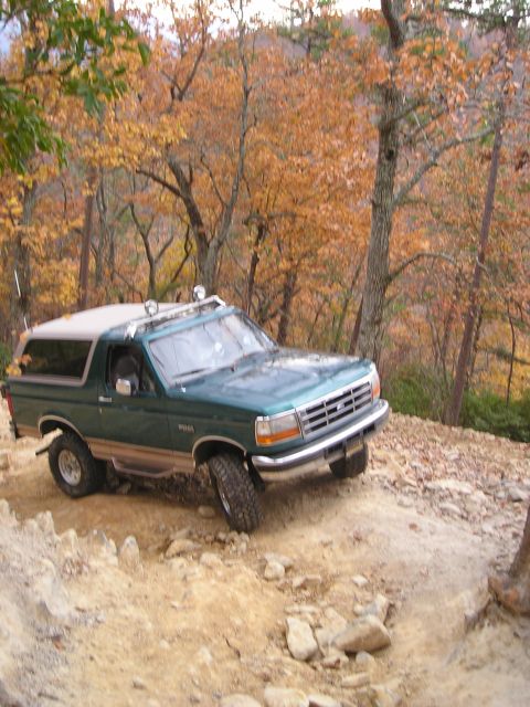 1996 Ford Bronco - 1996 Ford Bronco navigates a challenging rocky path during autumn.