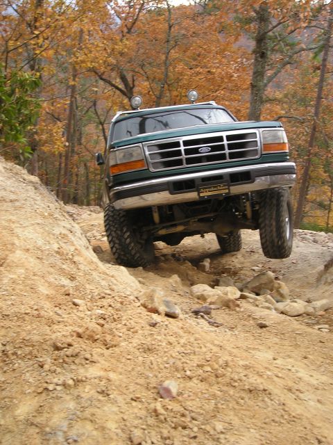 1996 Ford Bronco - This Ford Bronco navigates a challenging off-road trail during autumn.