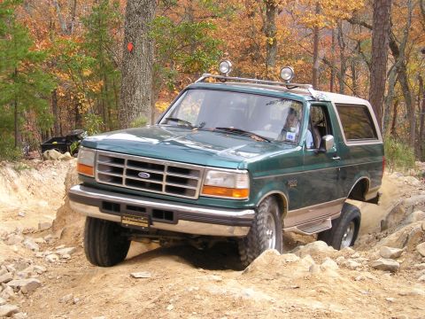 1996 Ford Bronco - This green 1996 Ford Bronco navigates a rocky, off-road trail during autumn.