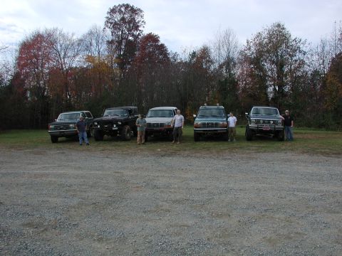 1985 Ford Bronco - A group of off-road vehicles are parked together in an outdoor lot.