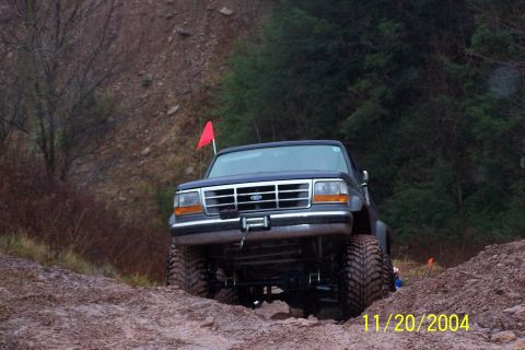 1979 Ford Bronco - This lifted Ford truck navigates a muddy off-road course with a red flag on its antenna.