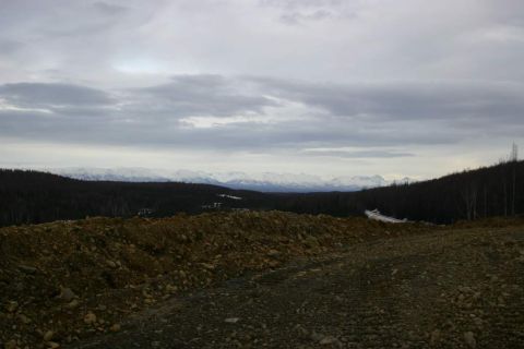 2003 Jeep TJ - Expansive view of a mountainous region under a cloudy sky, with foreground of rough terrain.