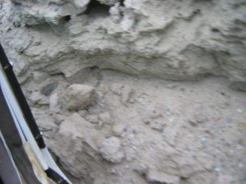 1985 Ford Bronco - A close-up view of a textured rock formation, possibly a cliff or embankment.