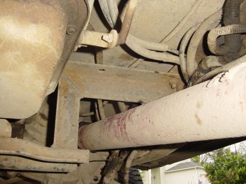 1987 Ford Bronco - Close-up view of the undercarriage, focusing on the drivetrain and suspension components.