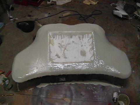 1999 Ford Taurus - A car dashboard component, possibly undergoing modification or repair, is covered in a white substance with a central rectangular opening.