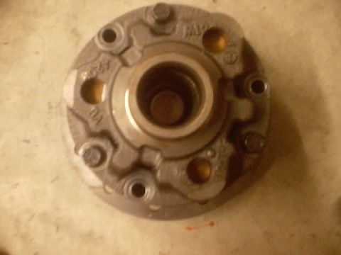 1989 Ford Bronco - Close-up view of a metal automotive part, possibly a hub or flange, with visible bolt holes and internal components.