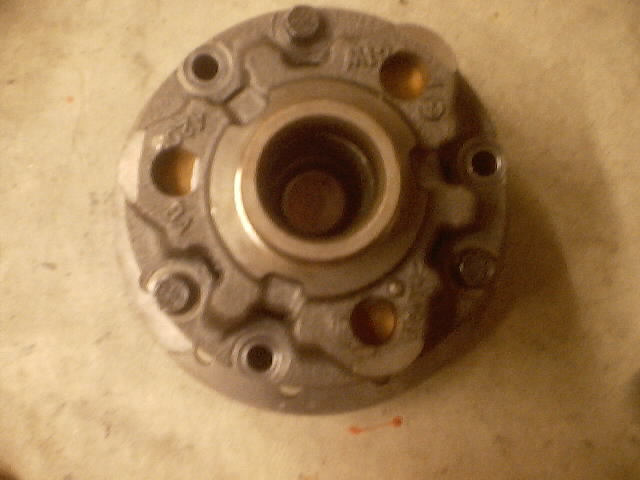 Close-up of a metal automotive part with bolt holes