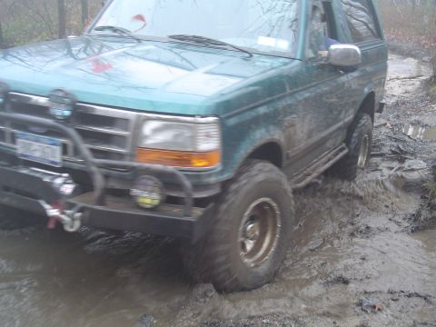 1993 Ford Bronco - This 1993 Ford Bronco navigates a muddy trail, its off-road capabilities.