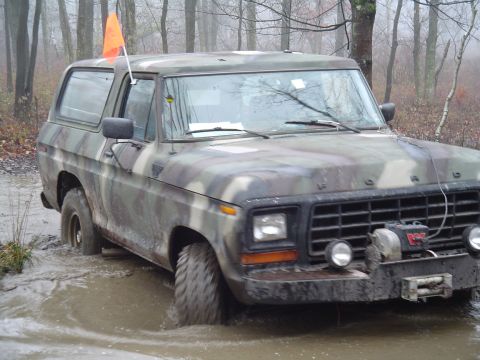 1993 Ford Bronco - This Ford Bronco is stuck in the mud, with an orange flag on top.