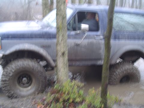 1993 Ford Bronco - This 1993 Ford Bronco is navigating a muddy, wooded trail.