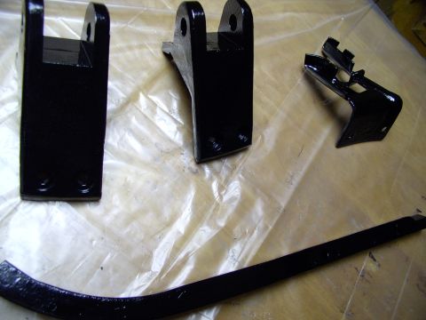 1986 Ford Bronco - Put the wire brush to these tailgate carrier parts. Then used a rust stopper (Loctite's Extend) then nailed em' with Krylon's rust paint.