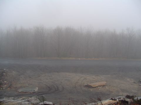 1993 Ford Bronco - A foggy day obscures a dirt road and a treeline.