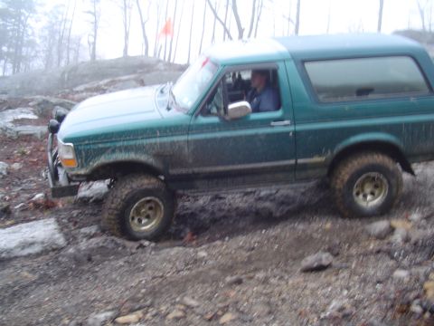 1993 Ford Bronco - This 1993 Ford Bronco is shown off-roading on a muddy, rocky trail.