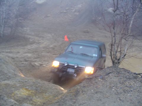 1993 Ford Bronco - This 1993 Ford Bronco tackles a challenging muddy terrain, demonstrating its off-road capabilities.