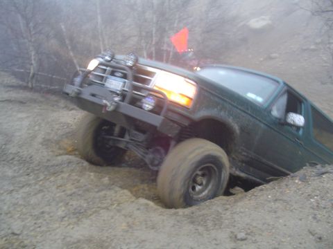 1993 Ford Bronco - Ford Bronco struggling on a muddy, off-road trail.