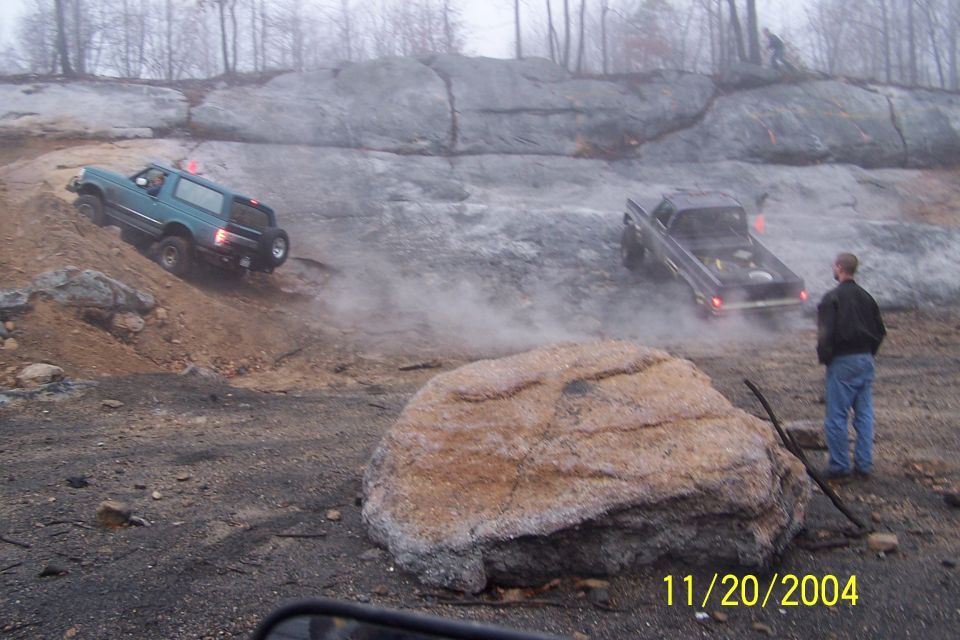 Teal 1979 Ford Bronco navigating rocky terrain