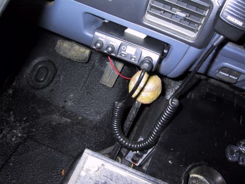 1993 Ford Bronco - A baseball hangs from the gear shift in front of a CB radio mounted in the vehicle's dashboard.