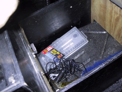 1993 Ford Bronco - A 40-piece glove box tool kit and a car charger are visible inside a vehicle's storage compartment.