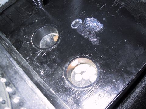 1993 Ford Bronco - A Cobra emblem is visible on a black surface with two circular openings, one containing white circular objects.