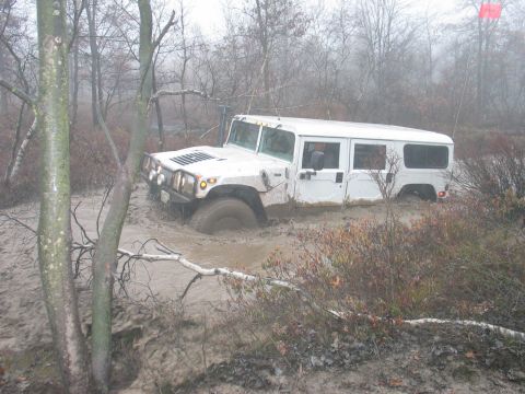 1995 Ford Bronco - White Hummer stuck in mud during an off-road excursion.