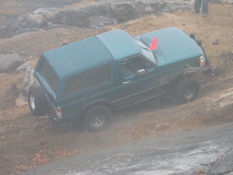 1995 Ford Bronco - This 1995 Ford Bronco navigates a challenging off-road course with a red flag on its windshield.