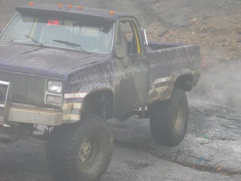 1995 Ford Bronco - This lifted pickup truck appears to be from the 1980s, not a 1995 Ford Bronco.