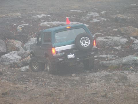 1995 Ford Bronco - This 1995 Ford Bronco navigates a challenging rocky course, its rear-mounted spare tire visible.