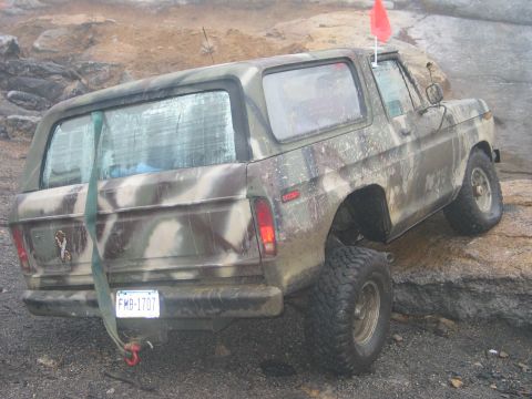 1995 Ford Bronco - This Ford Bronco is camouflaged and has a red flag on its roof.