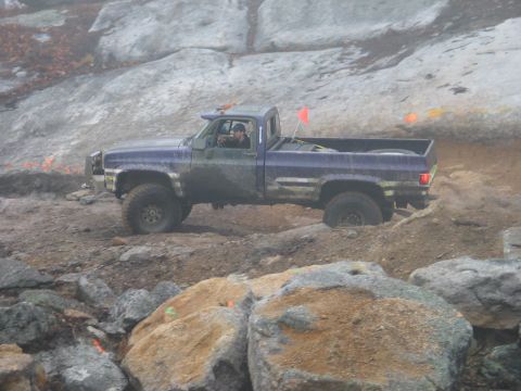 1995 Ford Bronco - A driver navigates a off-road course in a modified pickup truck.