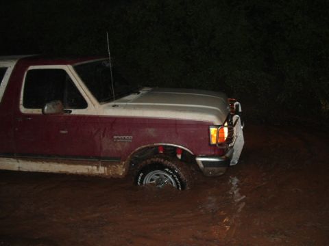 1990 Ford Bronco - This 1990 Ford Bronco is navigating through a flooded area at night.