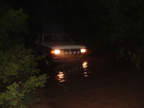 1990 Ford Bronco - This 1990 Ford Bronco is navigating through water in the dark.
